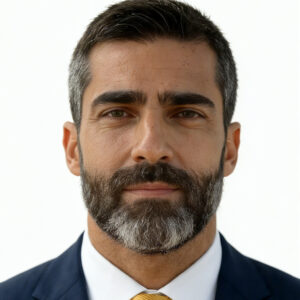 Professional headshot of a Miami SEO agency consultant wearing a navy blue suit and gold tie, clean background