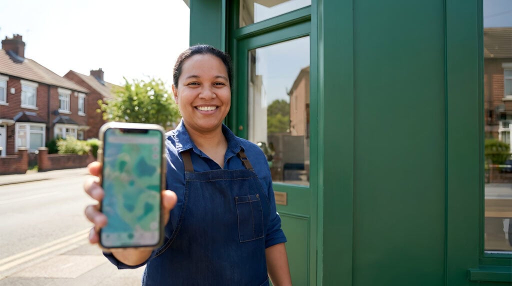 Local service business owner outside their storefront optimizing their Google Business Profile